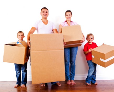 Removal team preparing a move in Brompton street with boxes and furniture