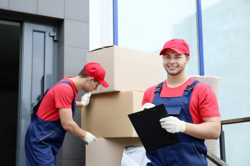 Movers working on a Brompton residential street with moving van and boxes