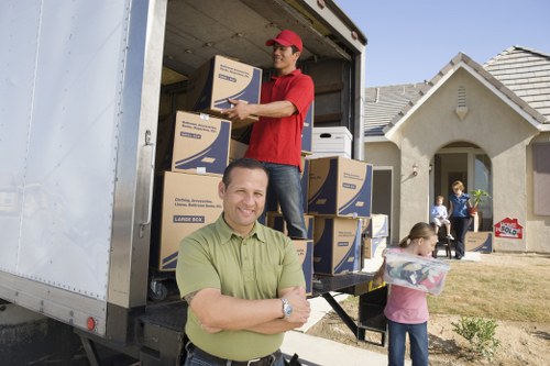 Removal van and moving crew at a Brompton commercial property