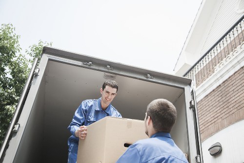 Movers handling furniture carefully in a Brompton property